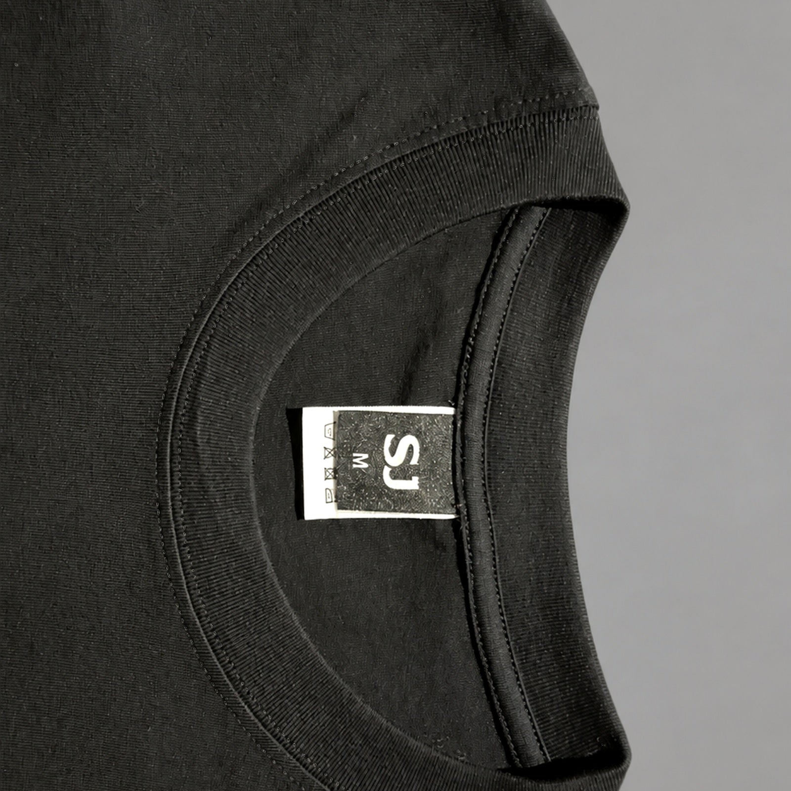 Black SJ Goods Tee collar and neck label construction