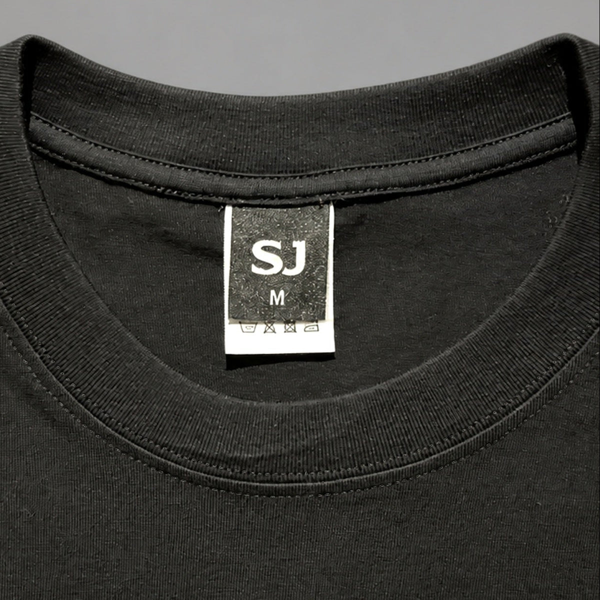 Black SJ Goods Tee — collar detail