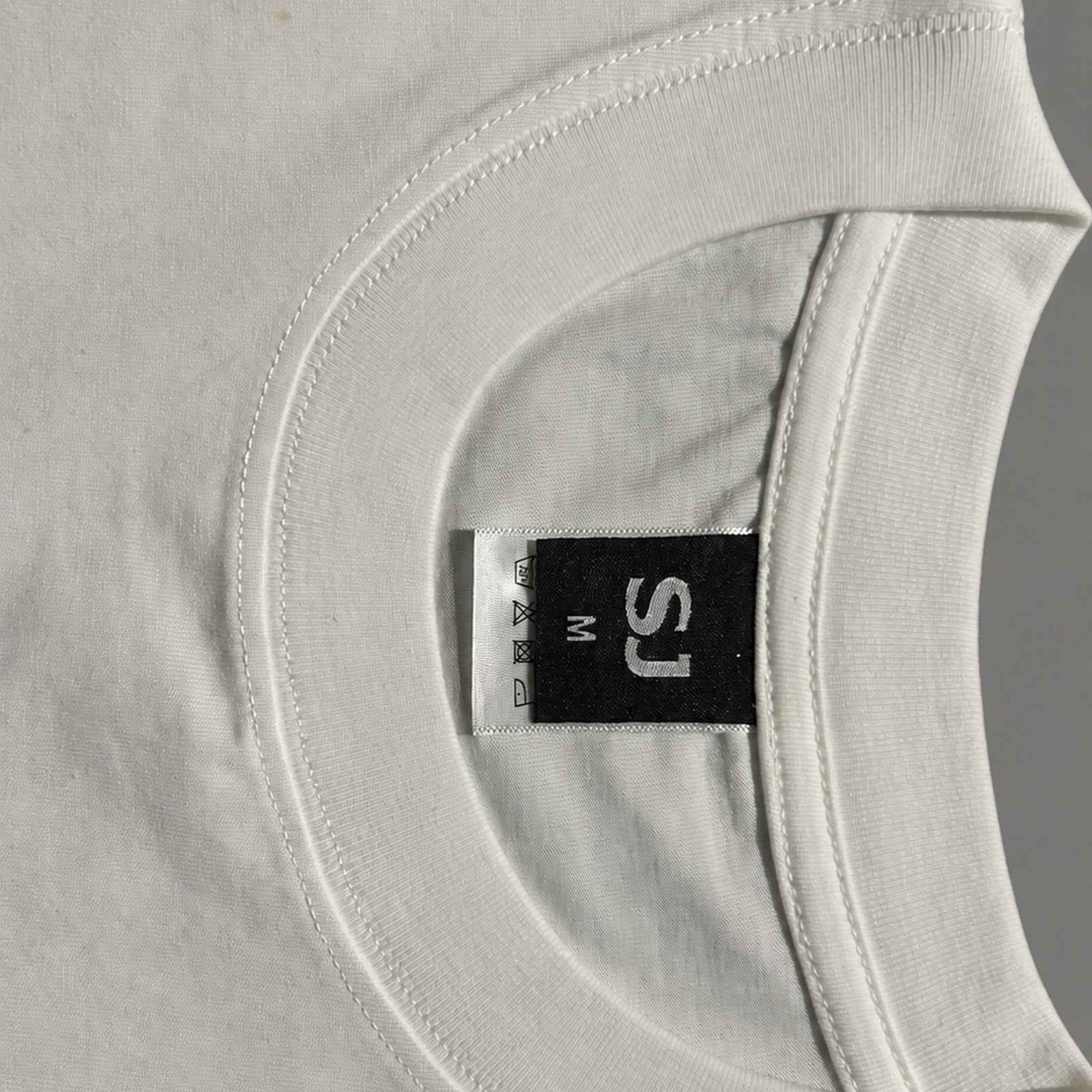 White SJ Goods Tee collar and neck label construction